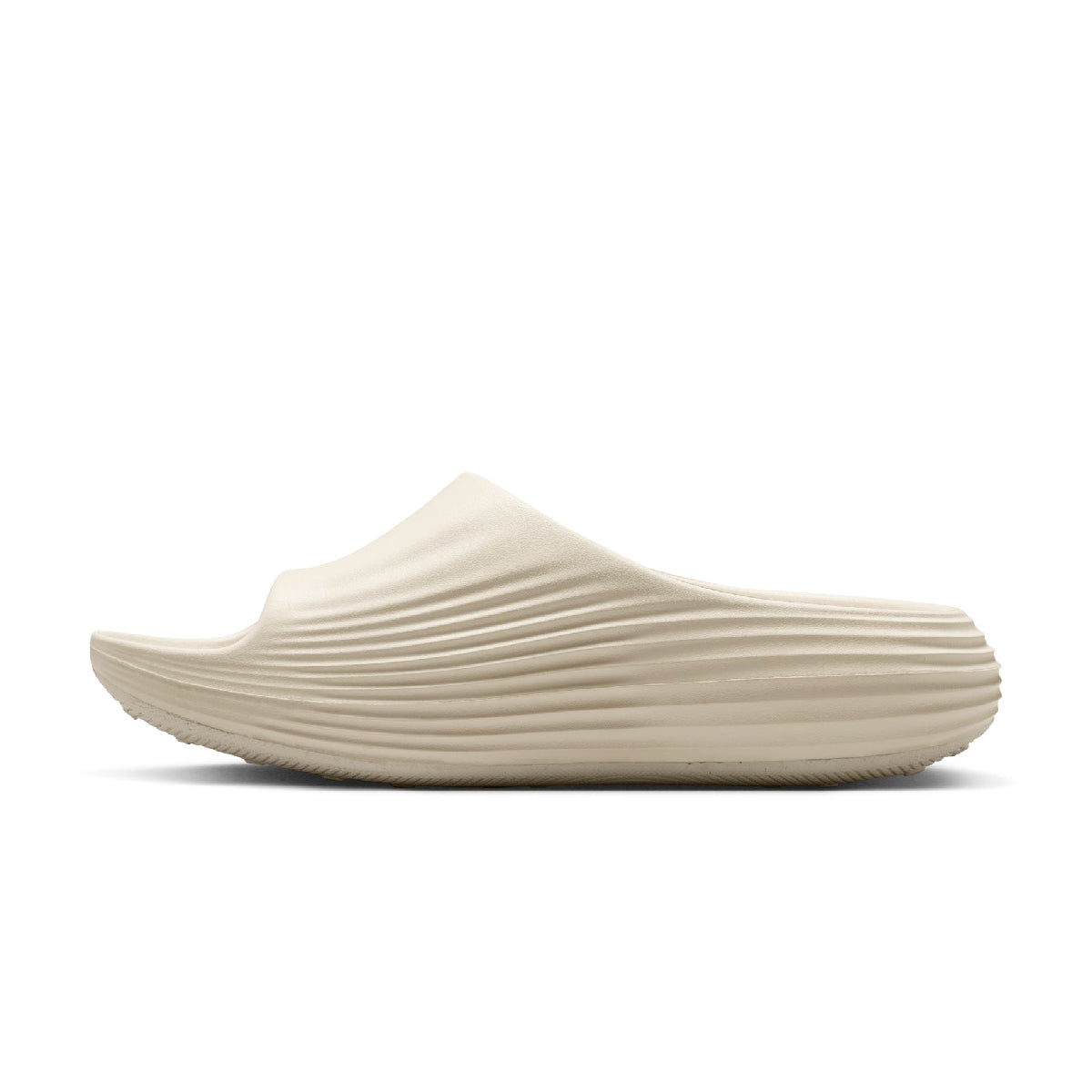 A single cream-colored slip-on clog shoe with a ribbed, textured sole, shown in a side profile view against a solid white background.