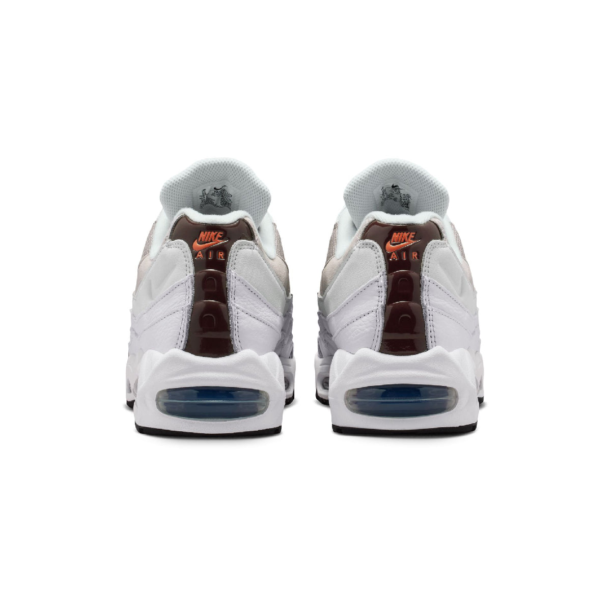 A pair of Nike Air Max 95 sneakers shown from the back, featuring a white leather upper with brown heel inserts, orange 'Nike Air' text, and a translucent blue Air Max sole.