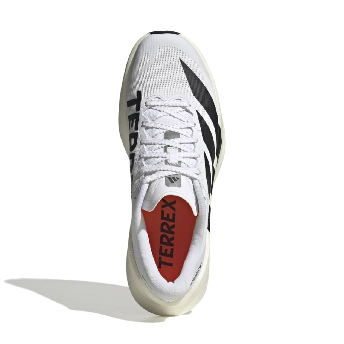 A white Adidas Terrex running shoe shown from a top-down view on a white background, featuring black three-stripes, black lettering, and a red inner lining.