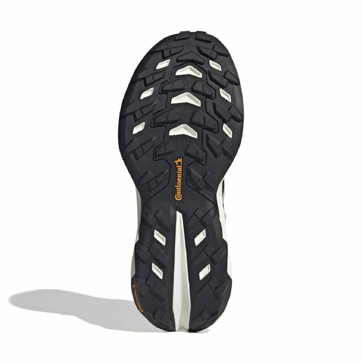 The black rubber outsole of a trail running shoe, showing the tread pattern and the orange Continental brand logo, set against a plain white background with a soft shadow.