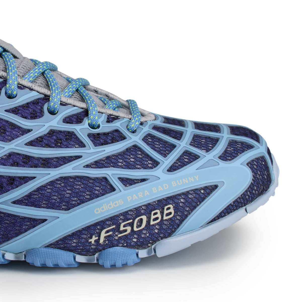 Close-up of an Adidas Para Bad Bunny running shoe in purple and light blue, showing the side profile with mesh upper, textured synthetic overlays, and the model name 'adidas PARA BAD BUNNY +F50BB' printed on the side.