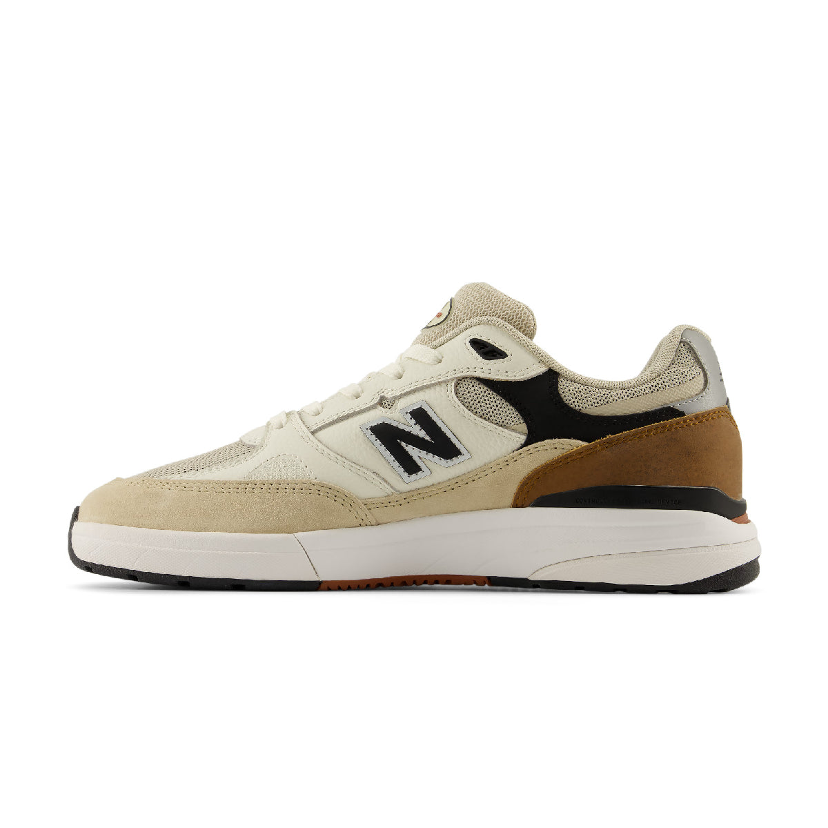 A New Balance sneaker in beige, brown, black, and white, shown from a side profile view against a plain white background.