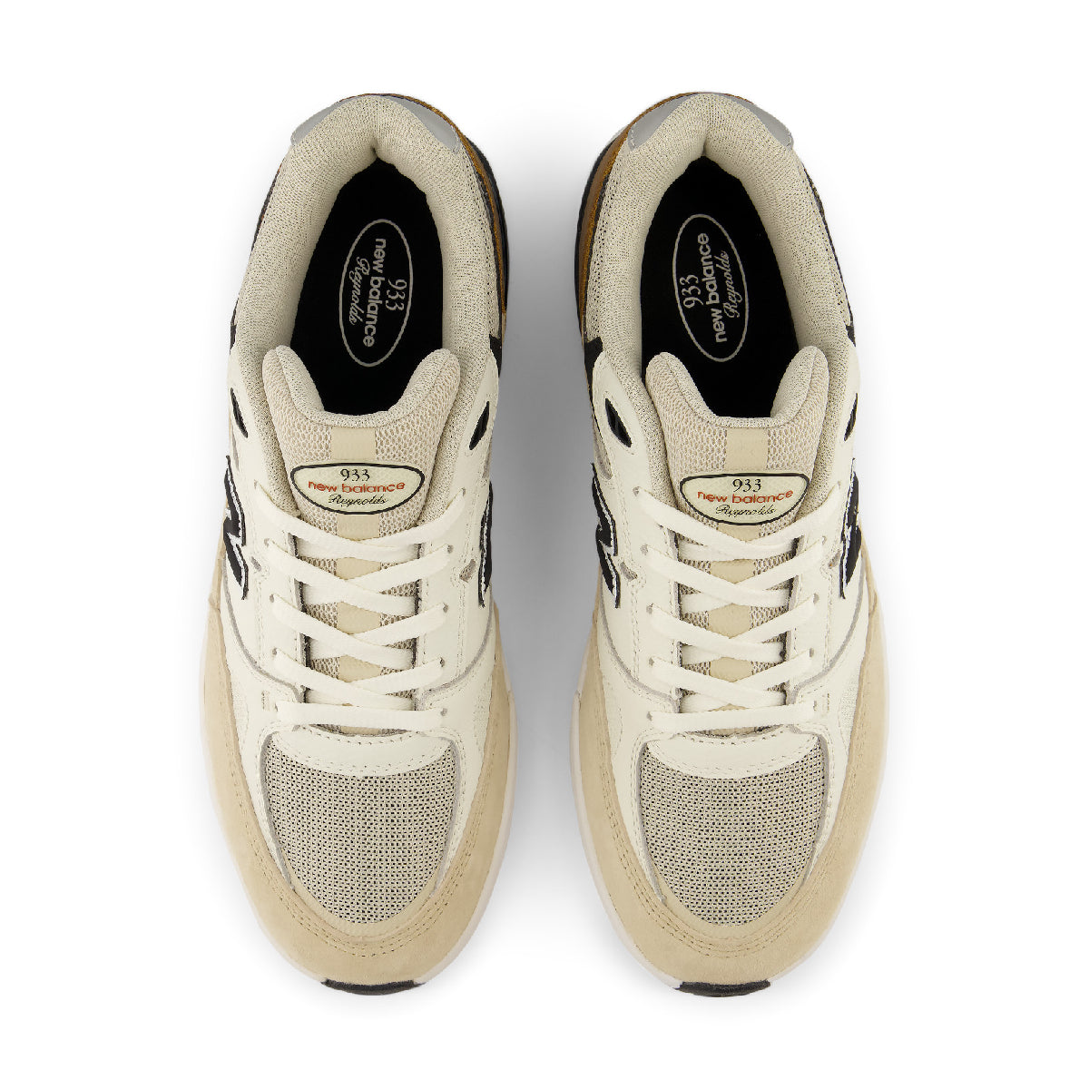A pair of New Balance 933 sneakers in cream and beige with black accents, shown from a top-down view on a white background.