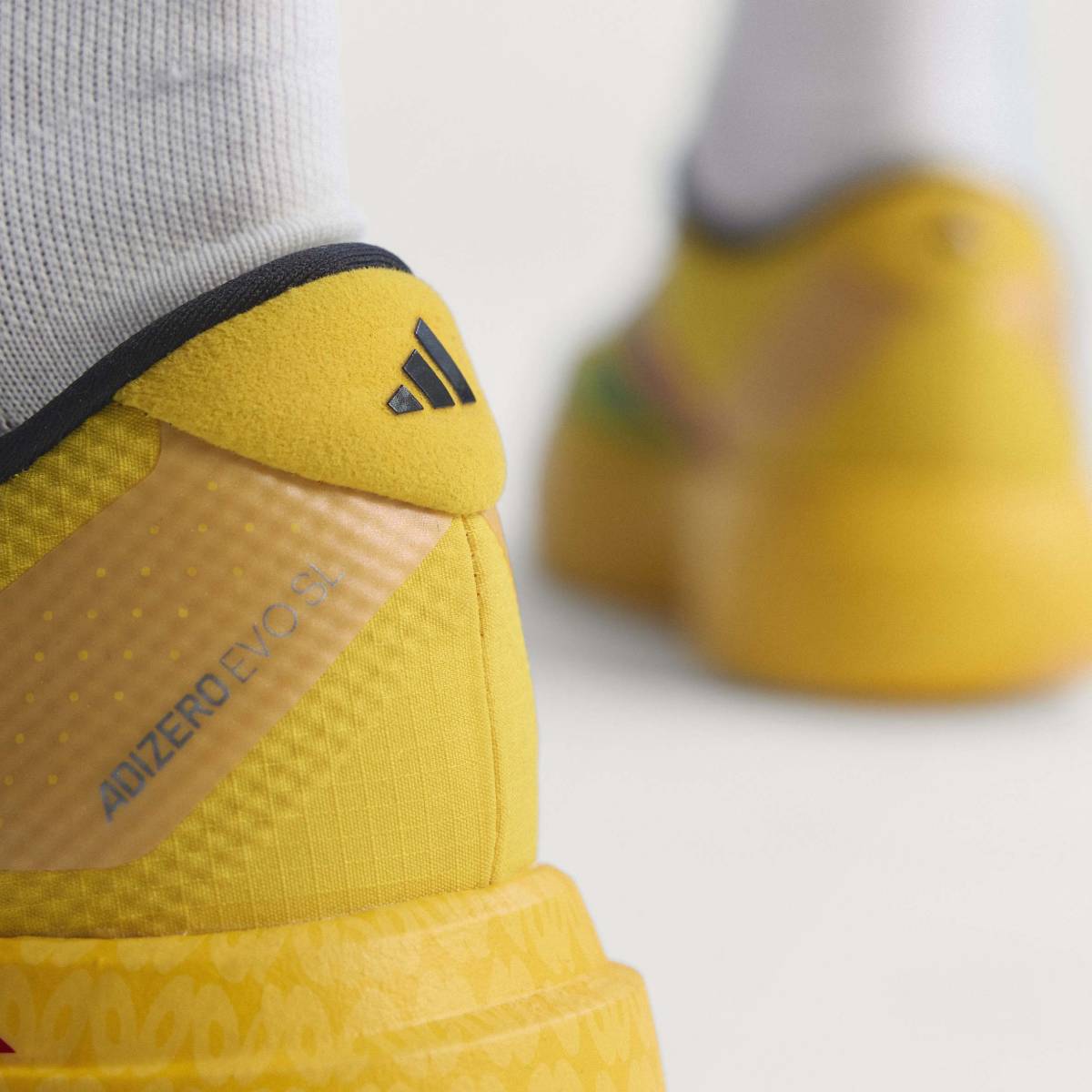 + Bob Marley Adizero Evo SL ‘Bold Gold’