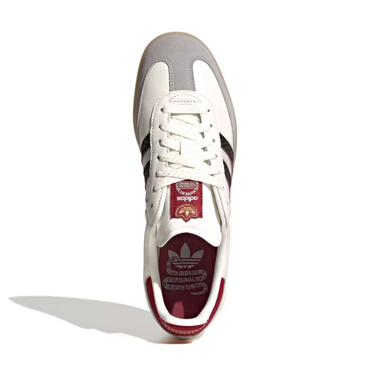 white adidas with maroon stripes