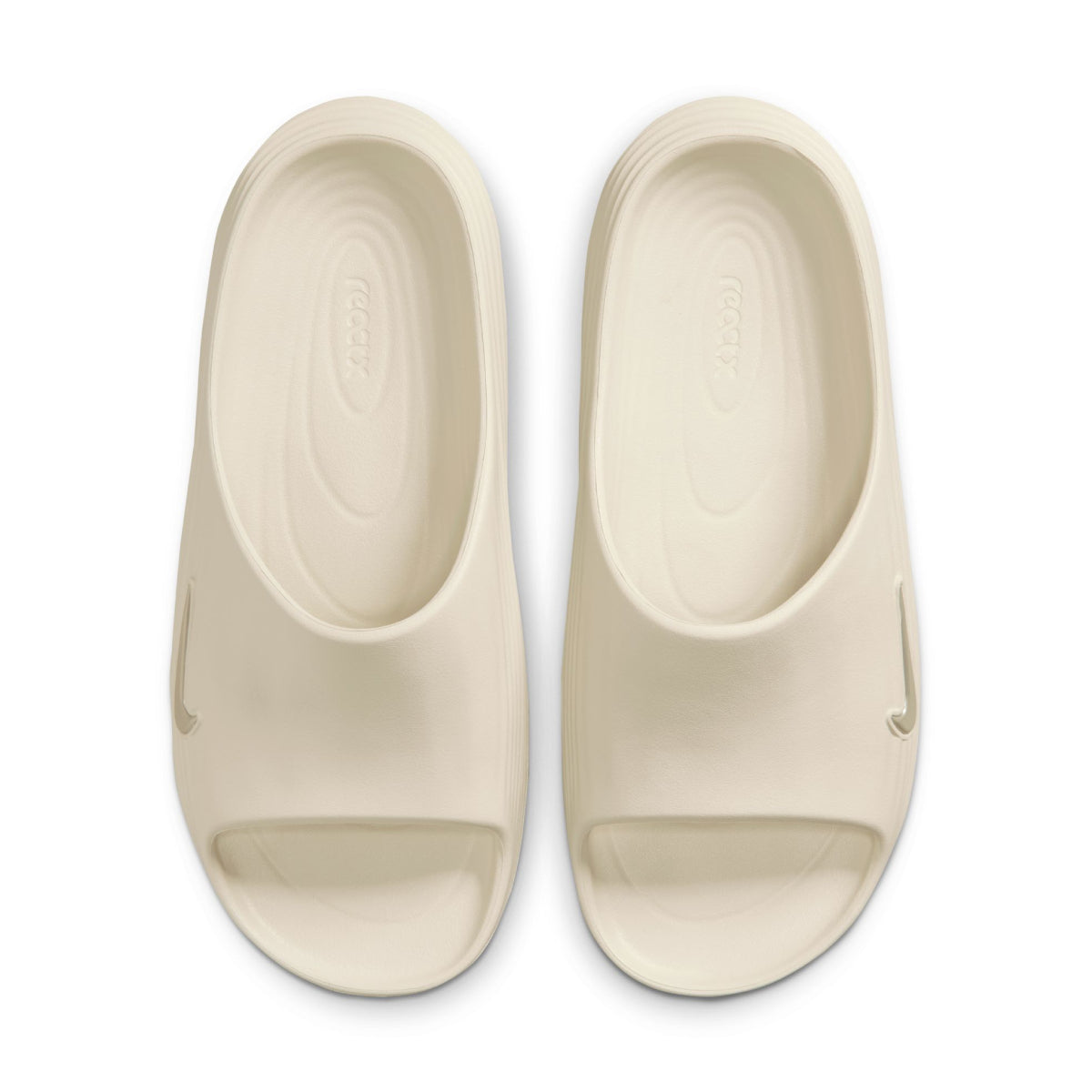 A pair of cream-colored slide sandals shown from a top-down view on a plain white background.