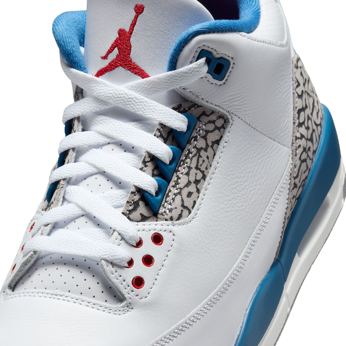 Close-up of a white Air Jordan 3 sneaker showing the side panel, white laces, red Jumpman logo, blue collar and midsole accent, and gray elephant print overlays.