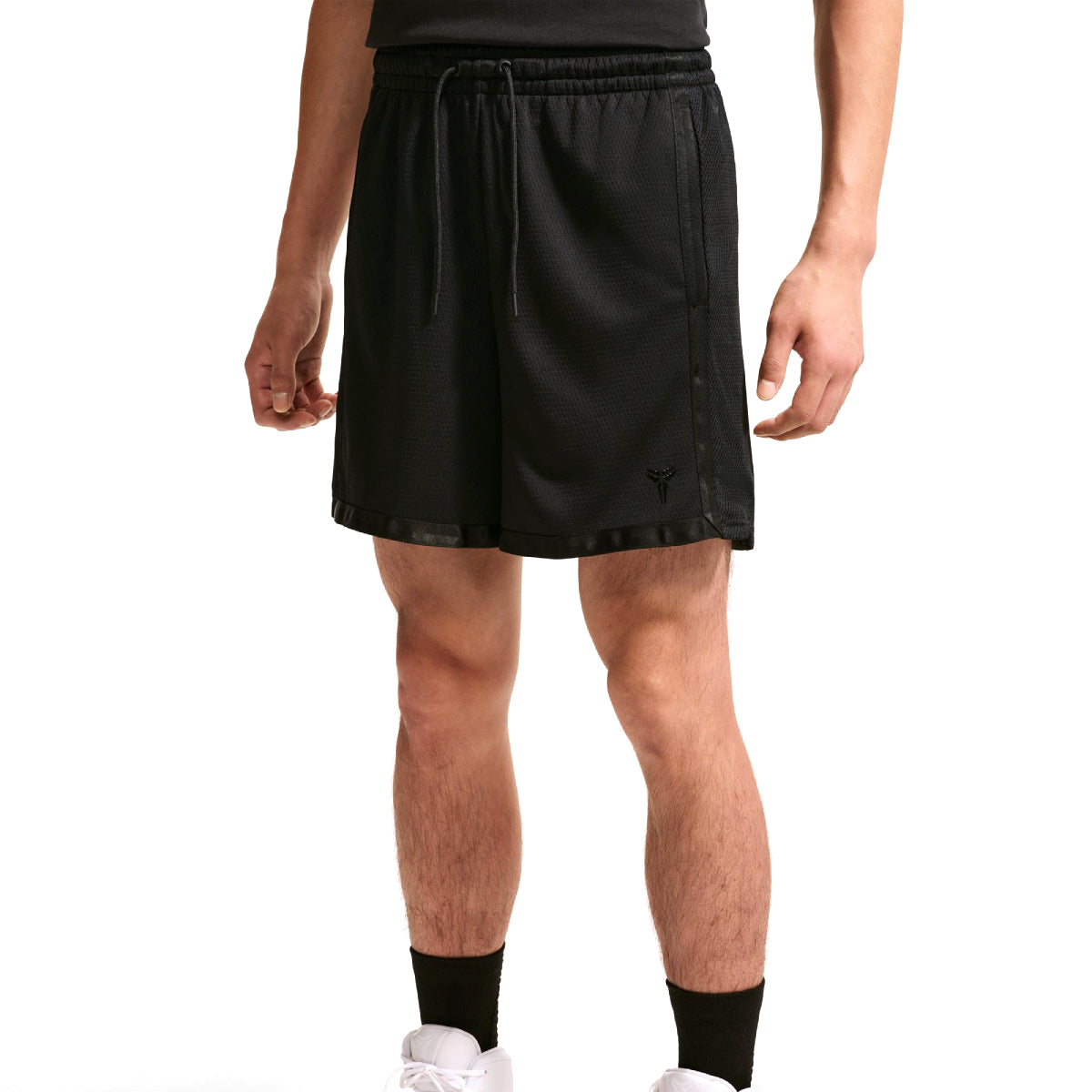 Black athletic shorts with a drawstring waist and side pockets, shown on a model from the waist down against a white background.