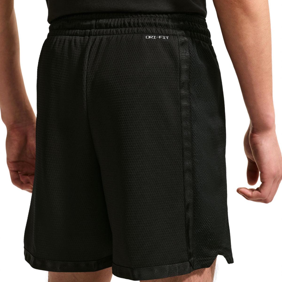 Black mesh athletic shorts with a side seam detail and a small white DRI-FIT logo on the waistband, shown on a model from the back.