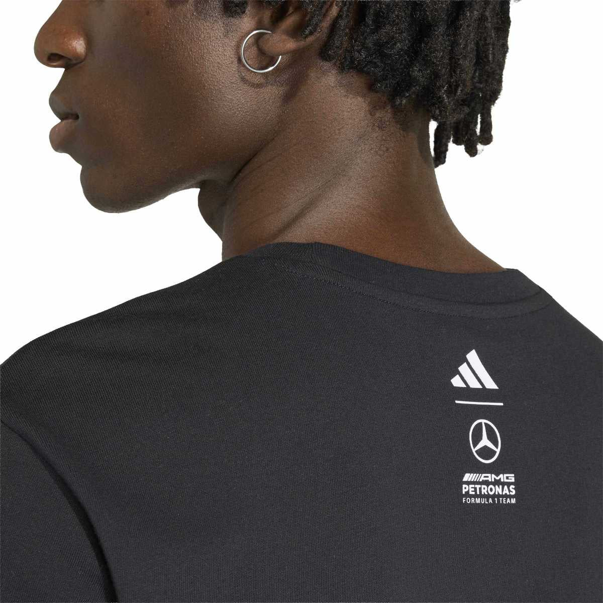 Person wearing a black shirt with Mercedes-Benz AMG Petronas Formula 1 Team logo.