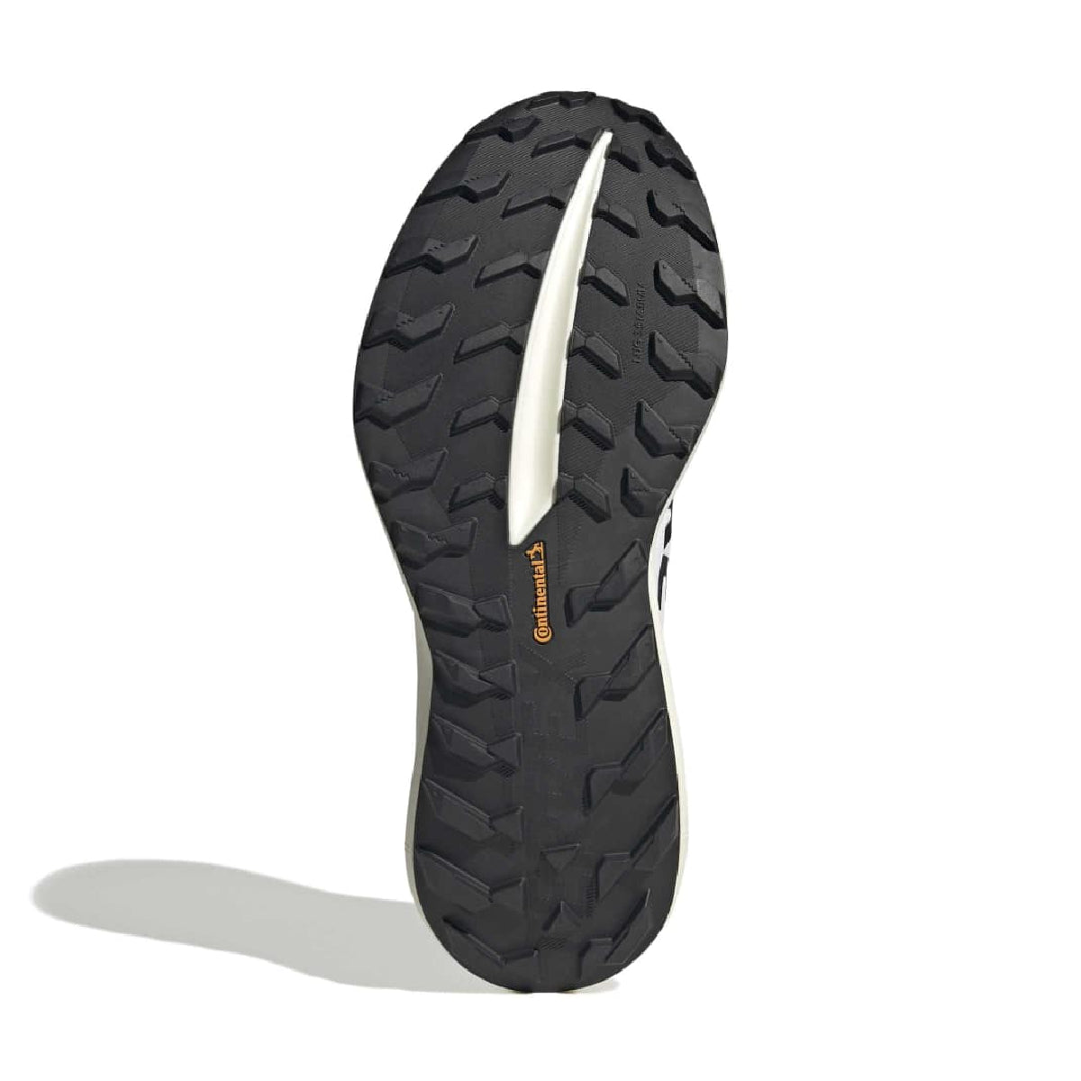 A close-up of a black athletic shoe sole with deep tread patterns, a white center channel, and a small orange Continental brand mark, shown on a white background with a soft shadow.