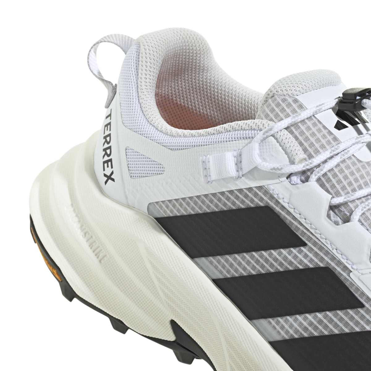 White Adidas Terrex sneaker with black stripes on a white background