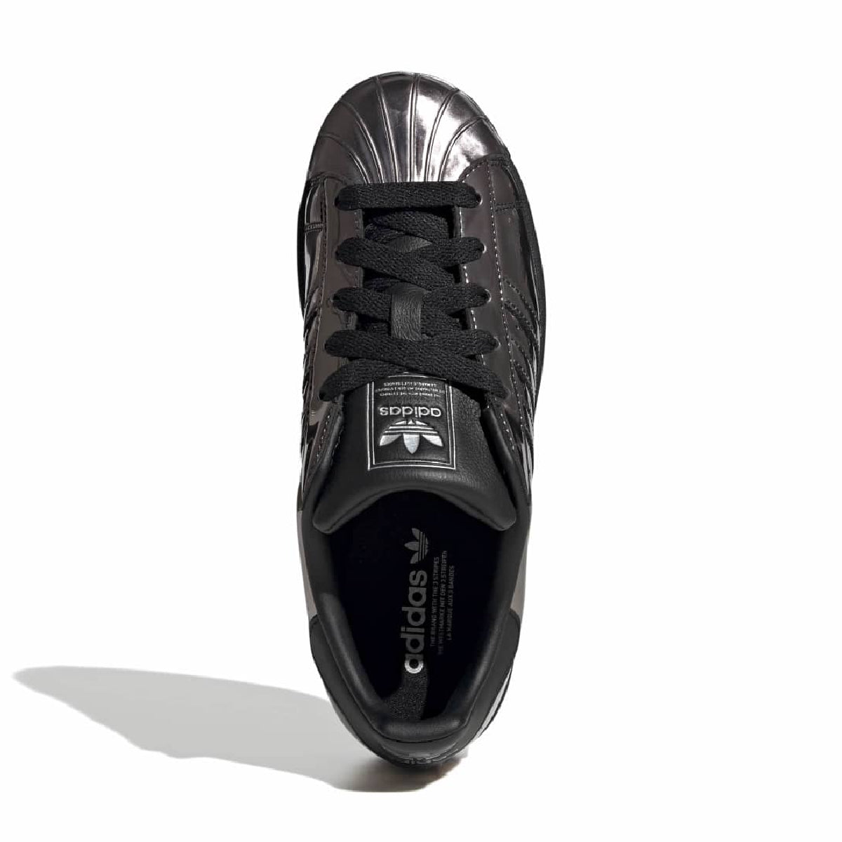 A single Adidas Superstar sneaker in metallic black, viewed from a top-down angle on a white background with a soft shadow.