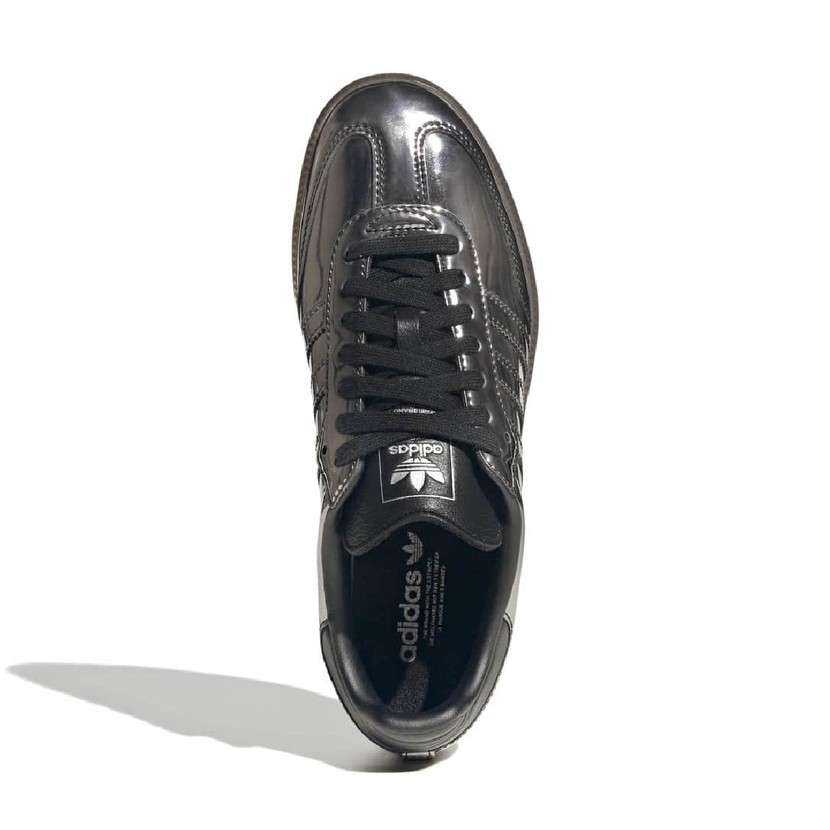 Black Adidas sneaker with white and blue stripes on a white background