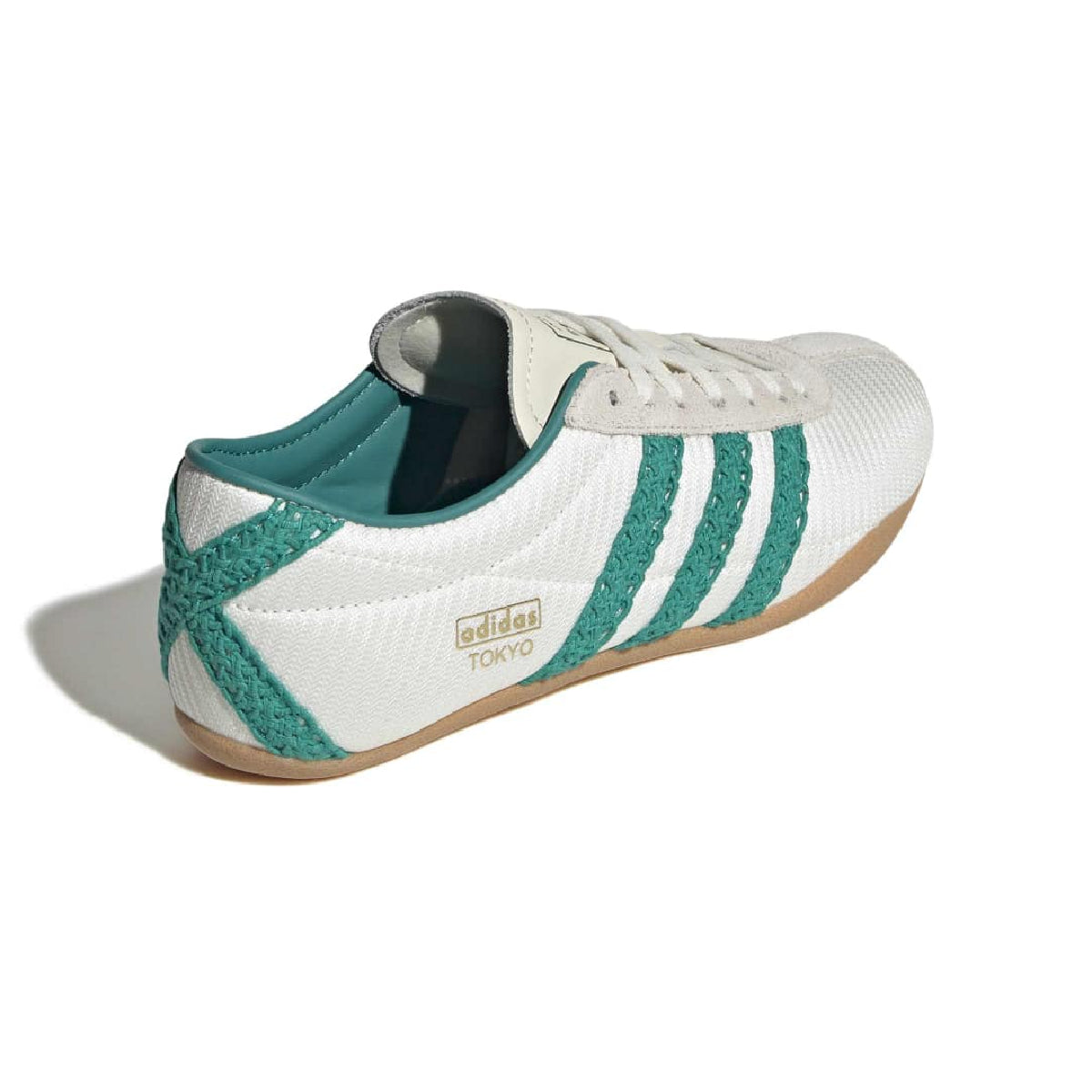 A white Adidas Tokyo sneaker with textured green stripes, a green heel tab, and a light brown gum sole, shown from a three-quarters angle on a white background.