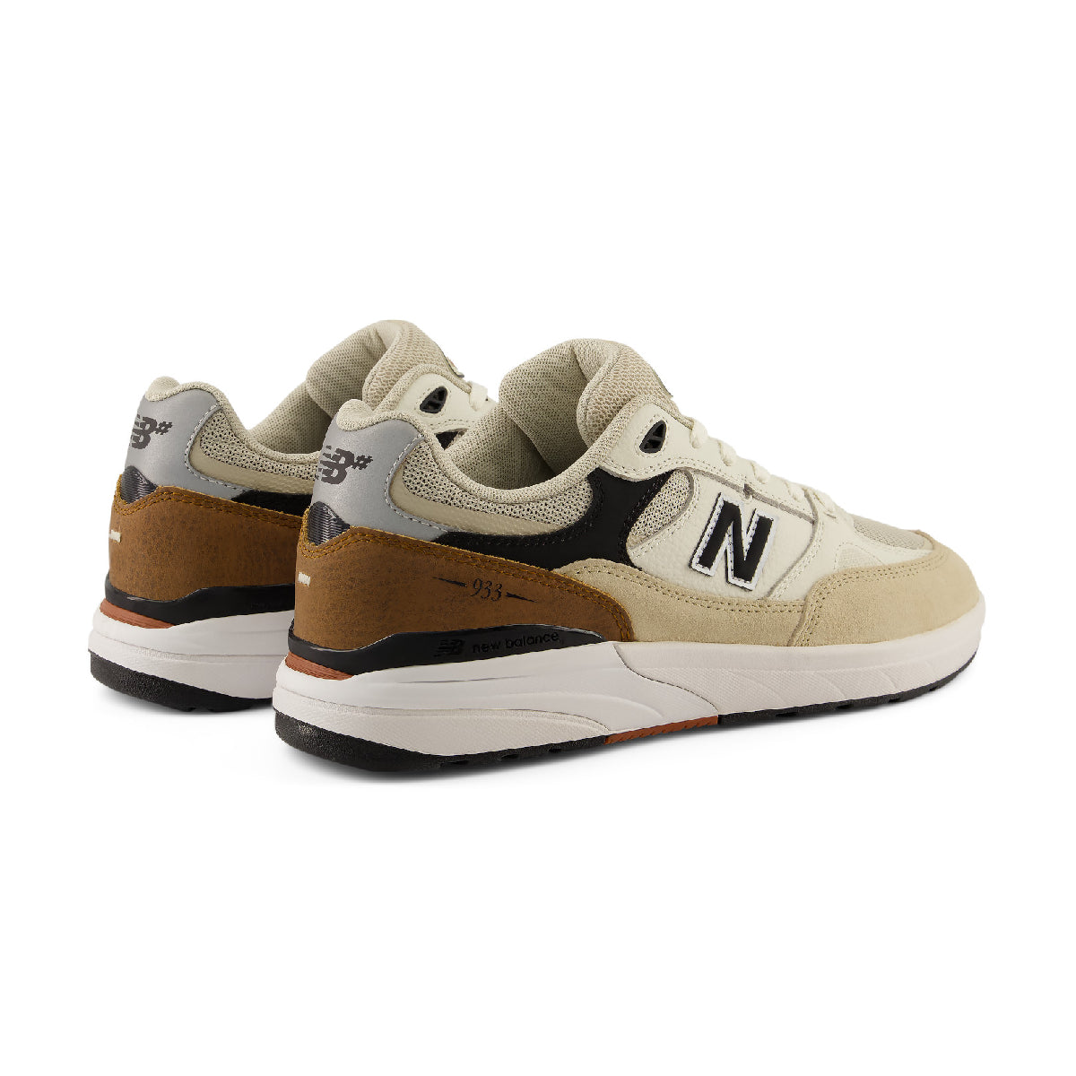 A pair of New Balance 933 sneakers in beige, brown, black, and white, shown from a three-quarters angle on a white background.
