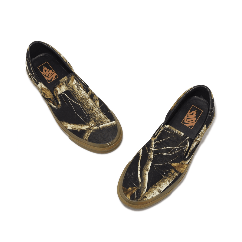 Black and gold top slip on vans